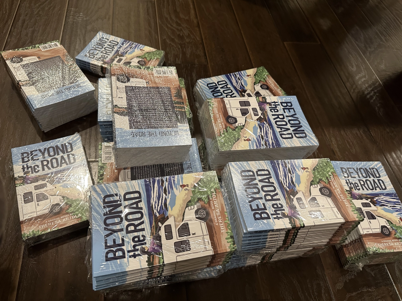 Pile of Belong to Road books wrapped in plastic stacks