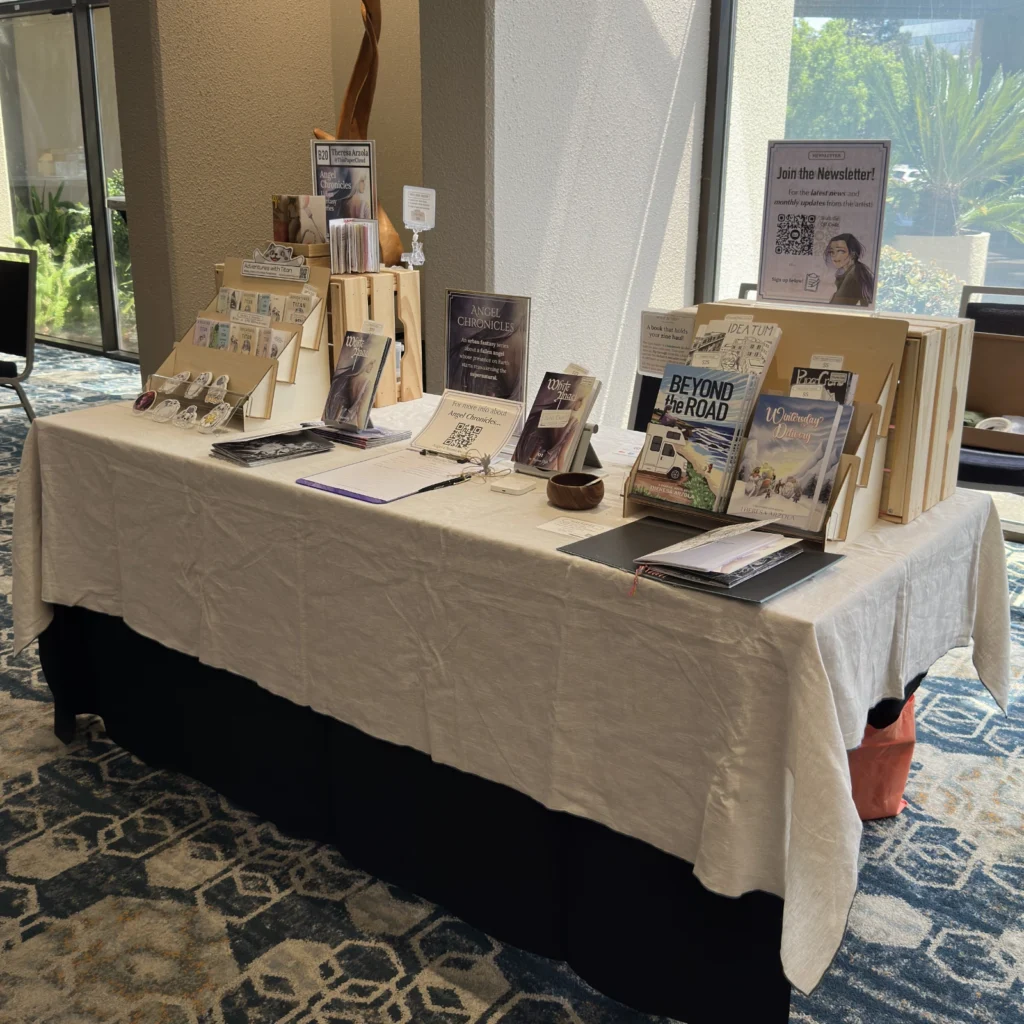 Table display of Theresa Arzola's (or ThisPaperCloud's) manga and zines.